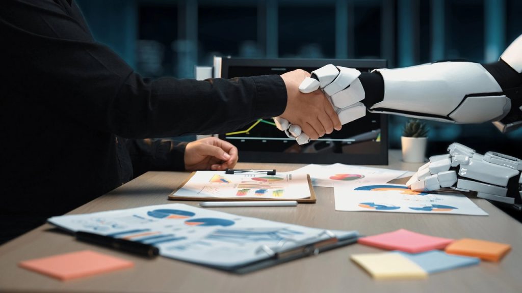 Mano humana y robótica estrechándose en entorno de análisis de datos.